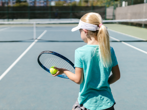 a girl is ready to play the tennis ball