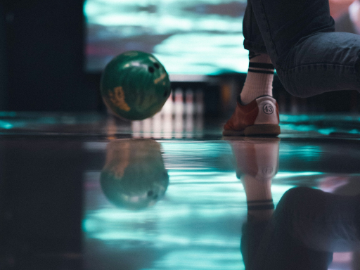 a green bowling ball was ready to hit the pins