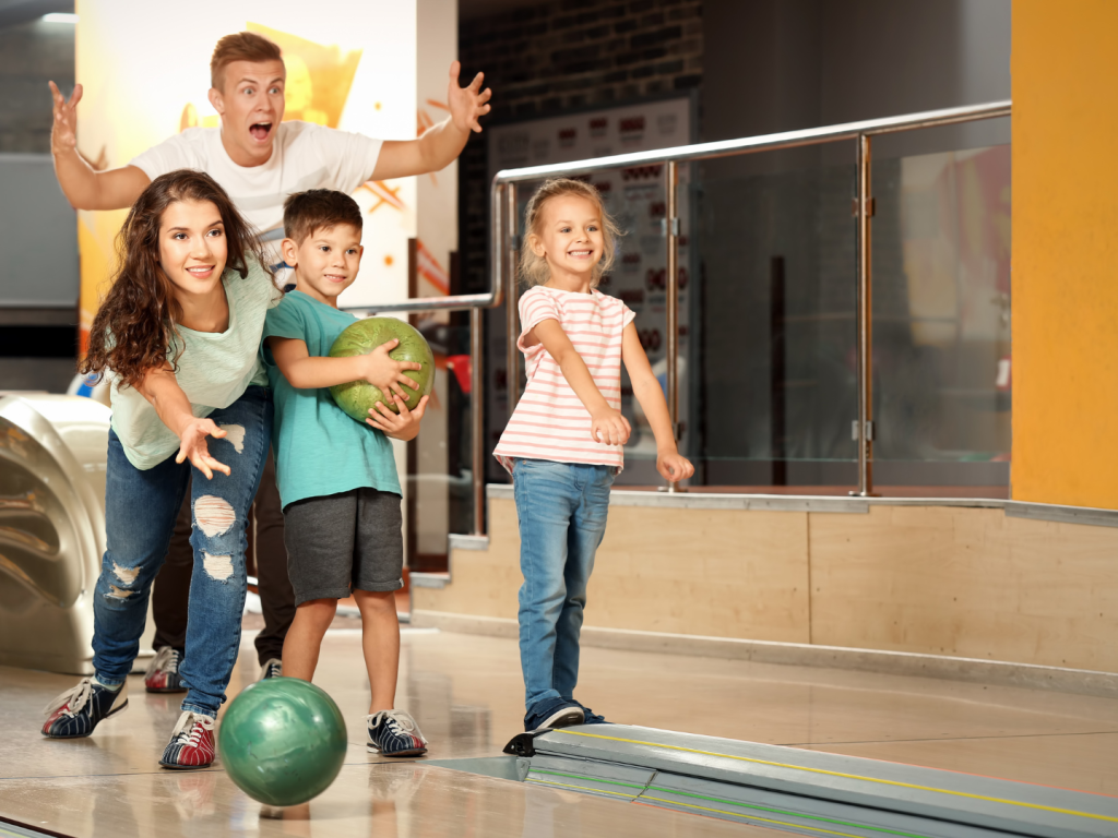 family-playing-bowling-in-a-bowling-alley