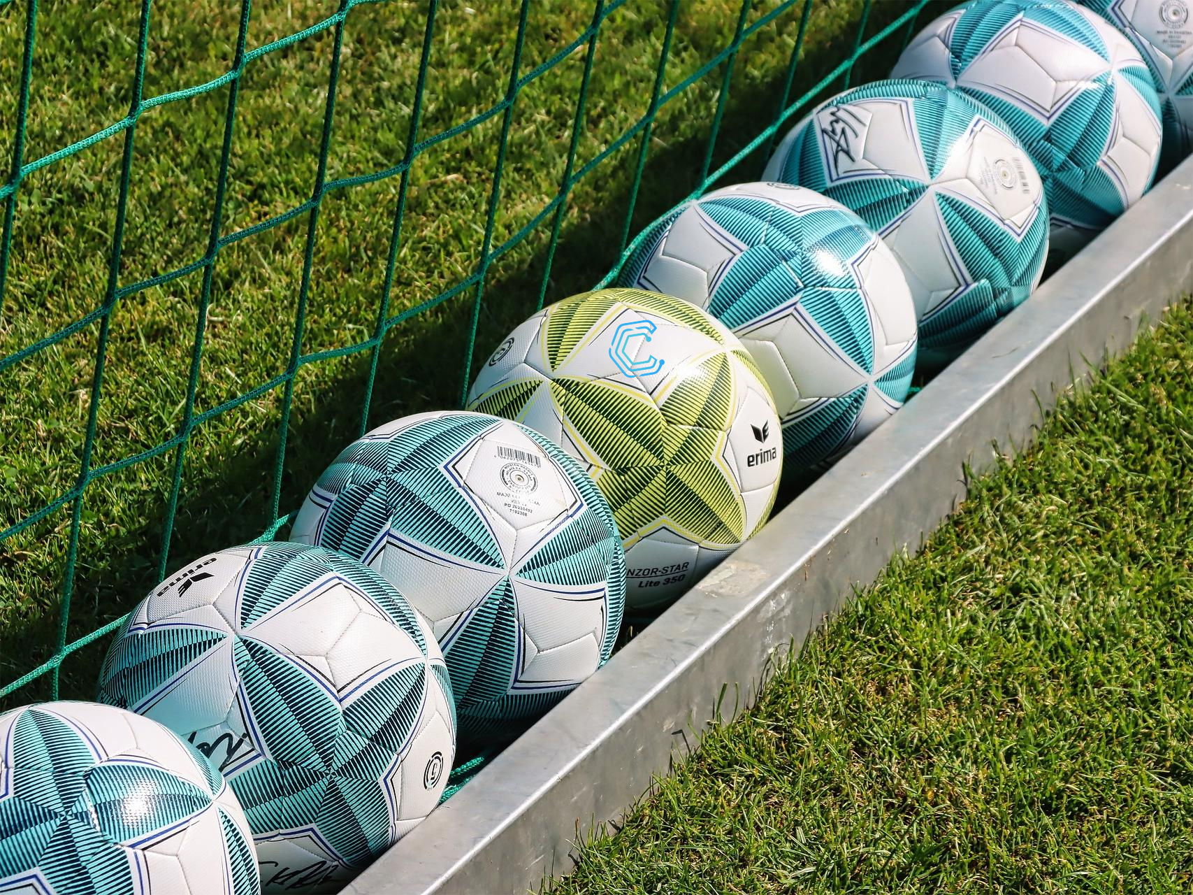 blue-and-green-footballs-on-the-grass